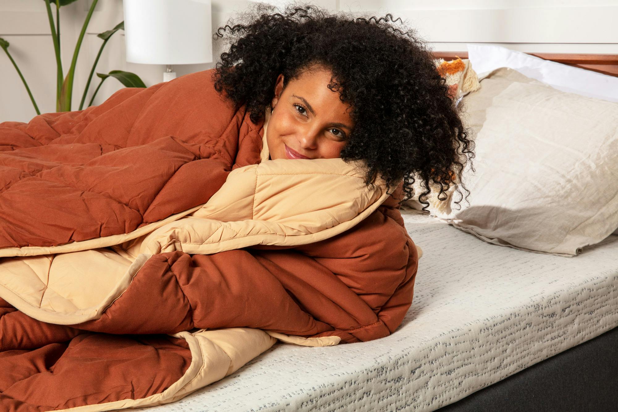 Woman wrapped up in a reversible comforter