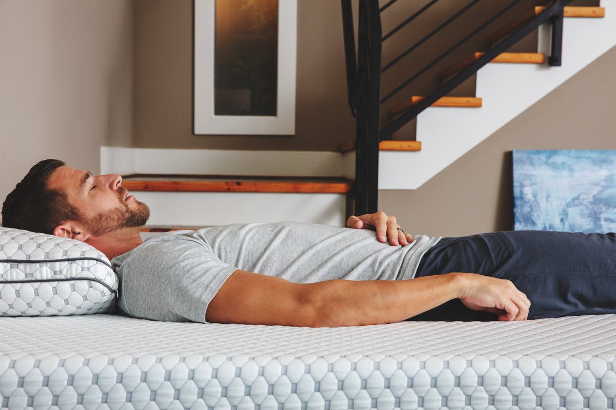 Photo of a man sleeping on his back