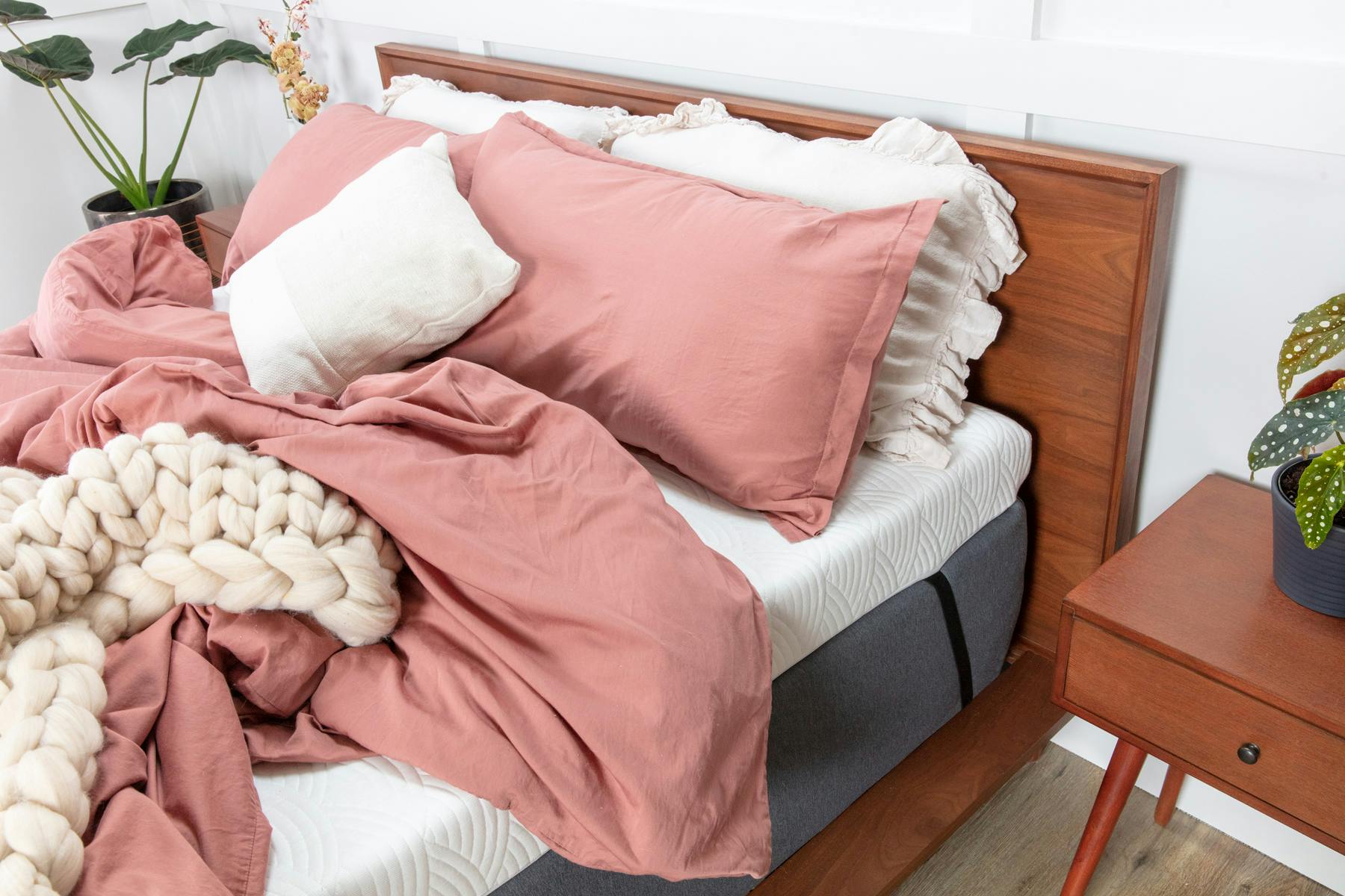 latex mattress topper on a queen bed frame in a college dorm