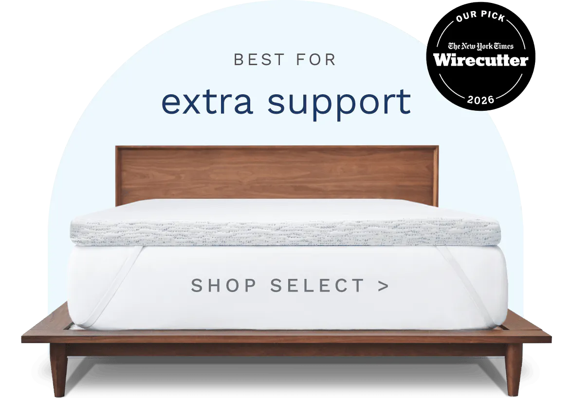 Best for extra support. Photo of a thick white and blue topper fitted to a mattress with white elastic adjustable straps.