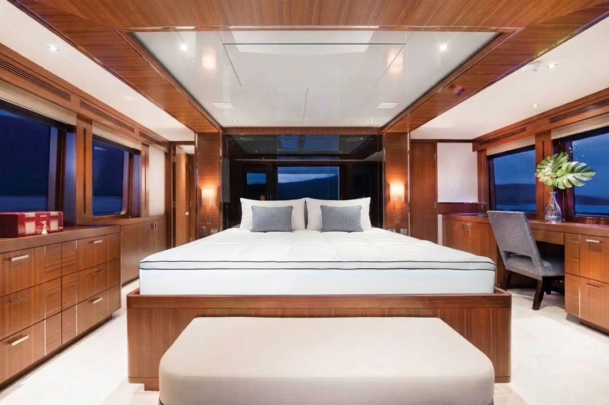 Photo of a sleeper cabin of a boat with a quilted white mattress topper on a bed
