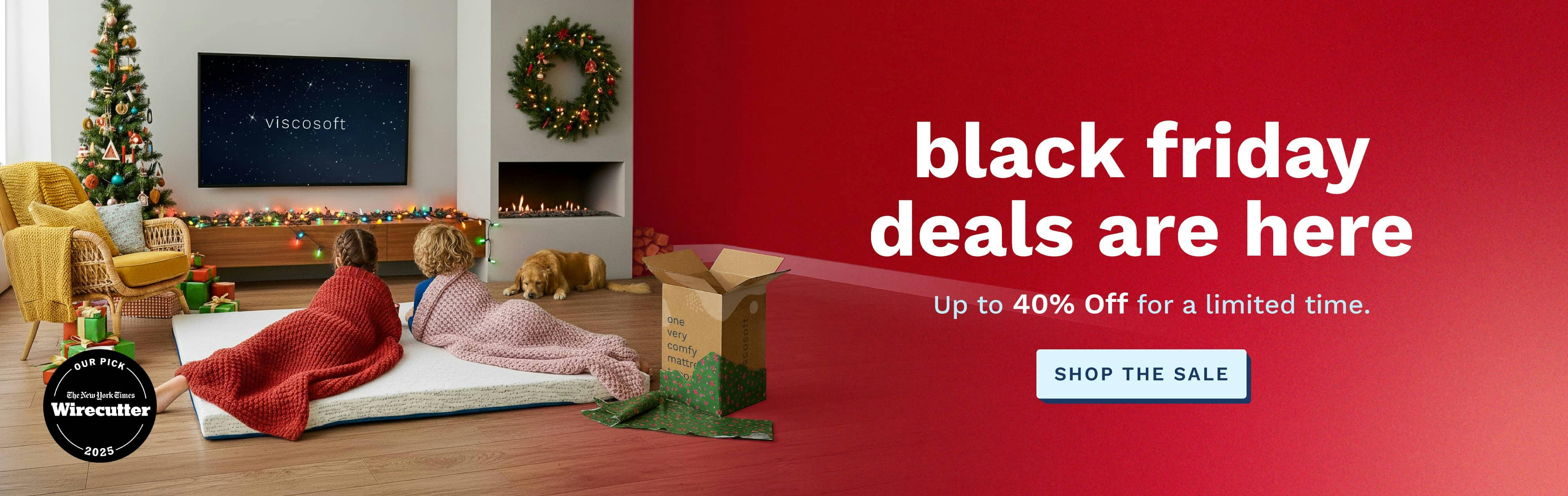 Text that says Black Friday deals are here. Up to 40% Off for a limited time. Imagery of two kids lounging on a mattress topper on the floor of the living room and watching tv.