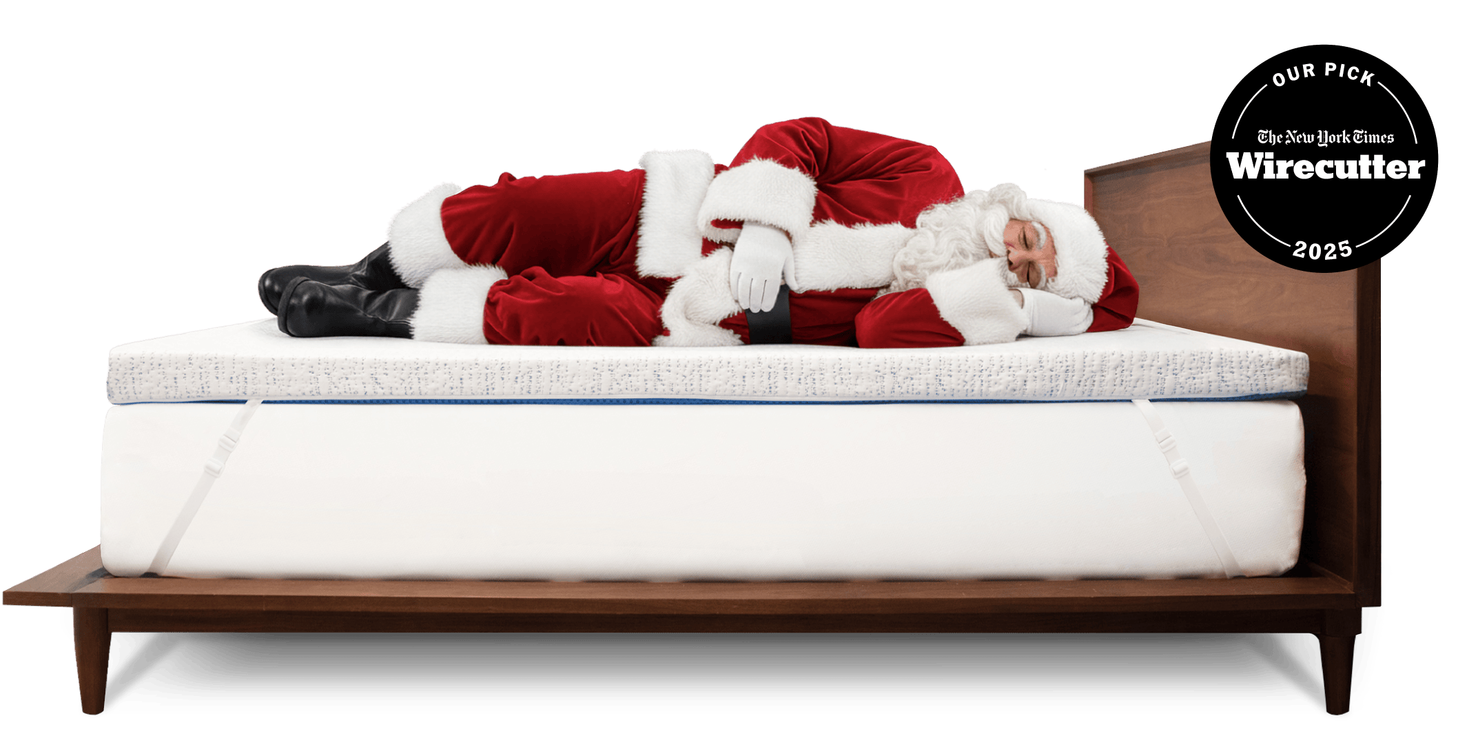 Santa Claus sleeping on a thick white mattress topper