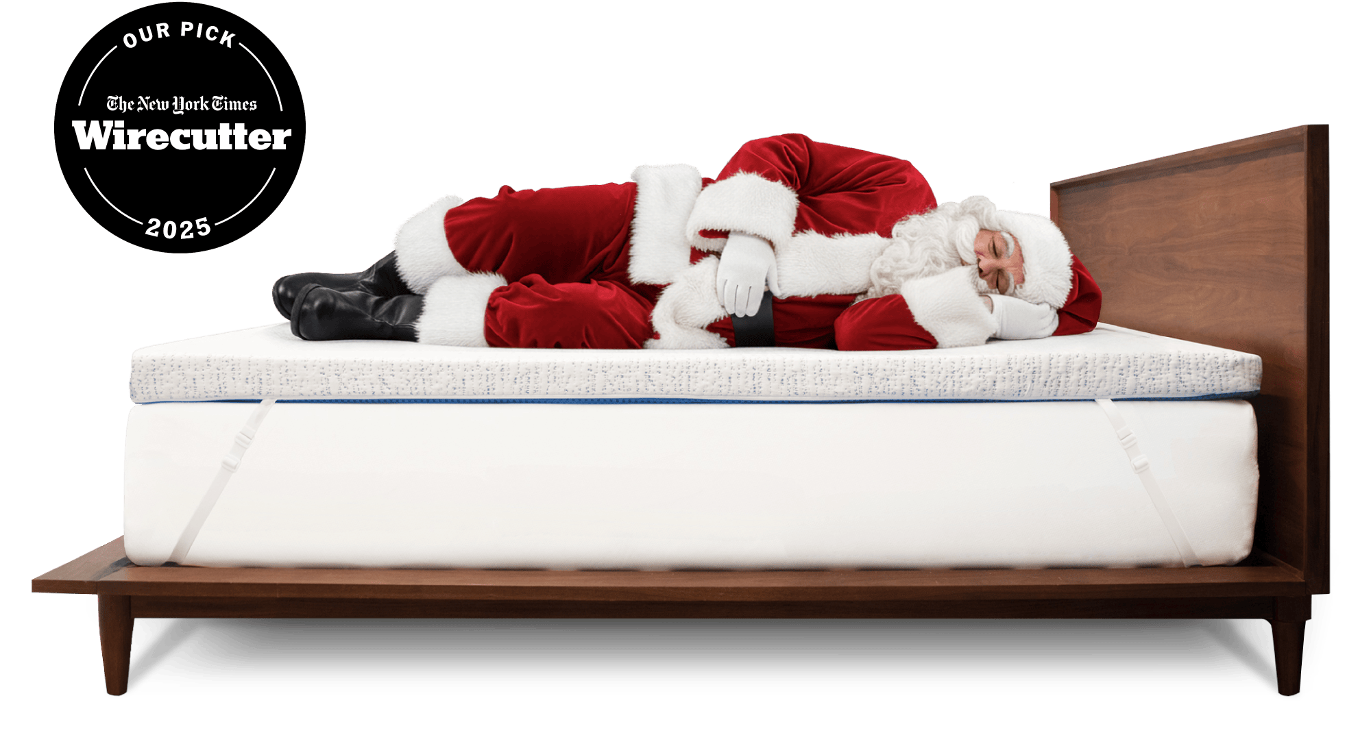 Santa Claus sleeping on a thick white mattress topper