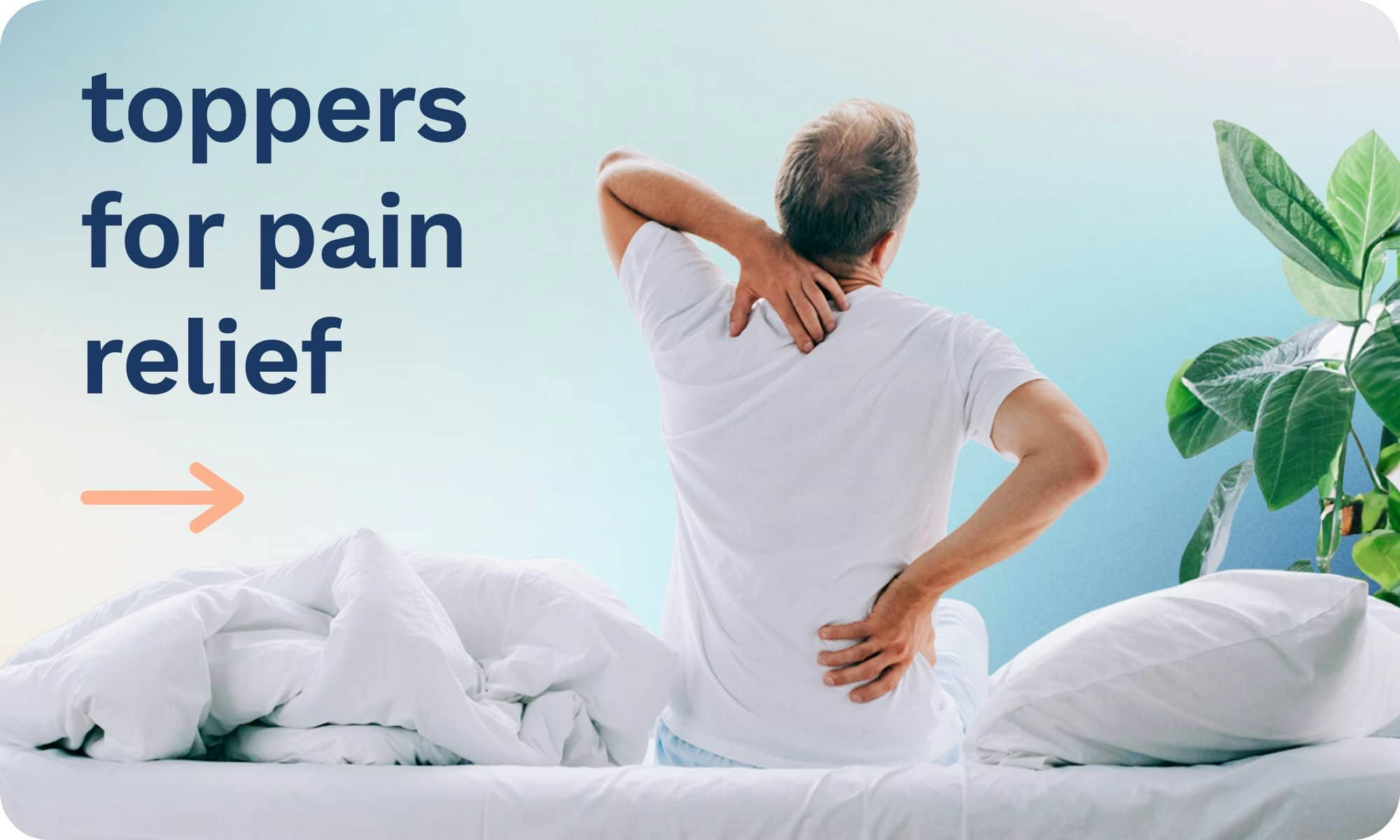 Toppers for Pain Relief; An older man sitting on a bed gripping his shoulder and back in pain.