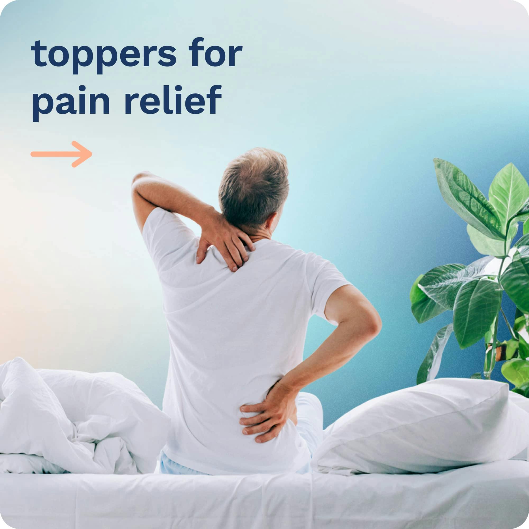 Toppers for Pain Relief; An older man sitting on a bed gripping his shoulder and back in pain.