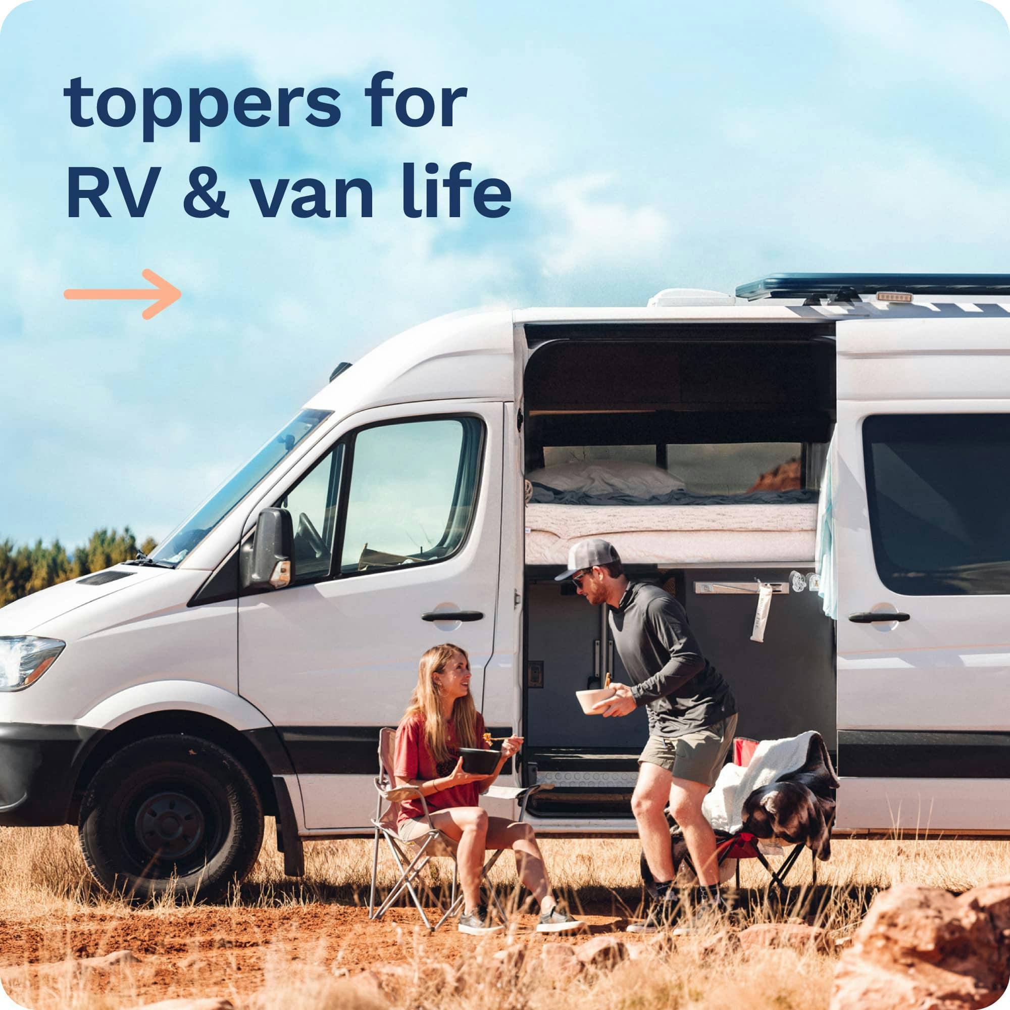 Toppers for RV & Van Life; A young couple sitting in camping chairs outside of their camper van; Camper van has door open showing bed with a mattress topper.