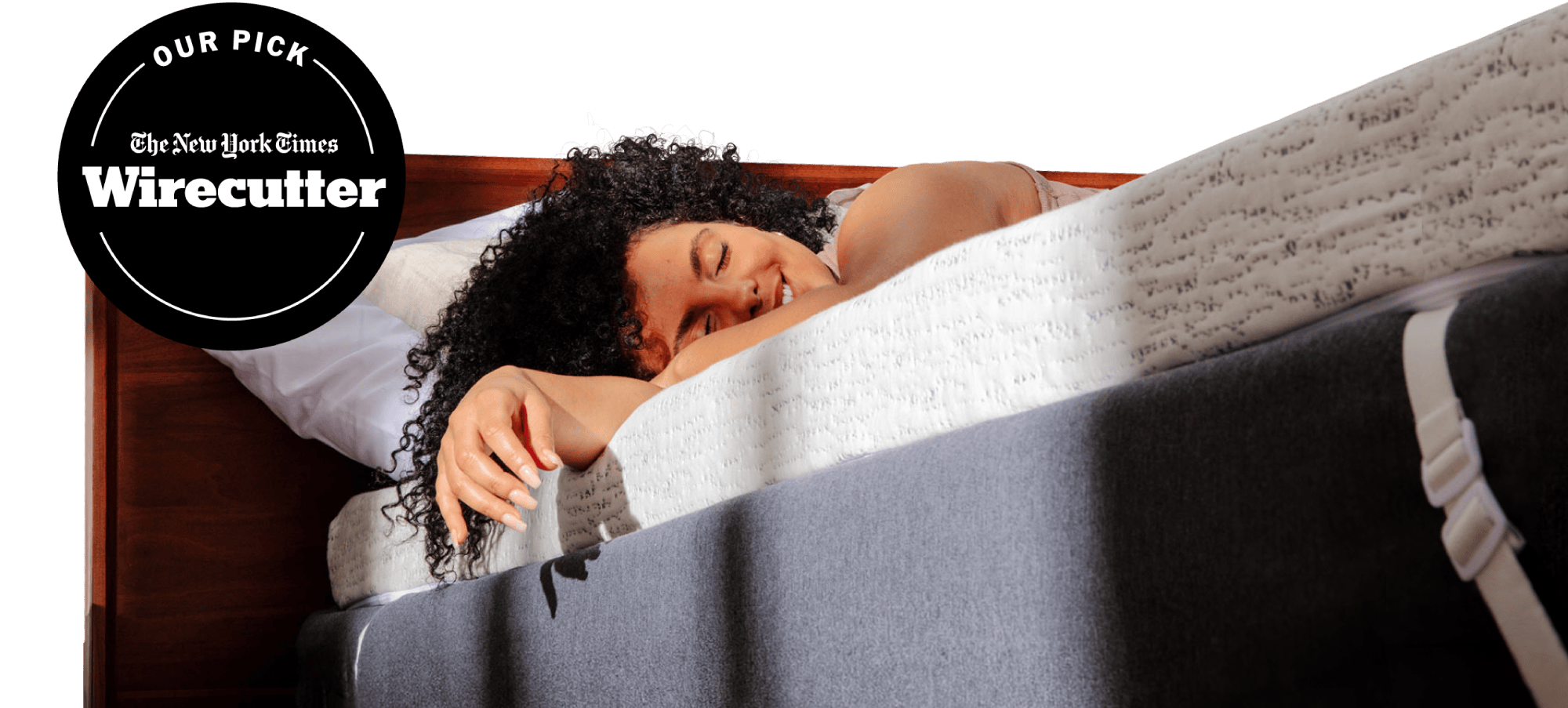NYT Wirecutter's pick for best memory foam mattress topper; a woman relaxing on a thick white and blue mattress topper with morning light streaming on her