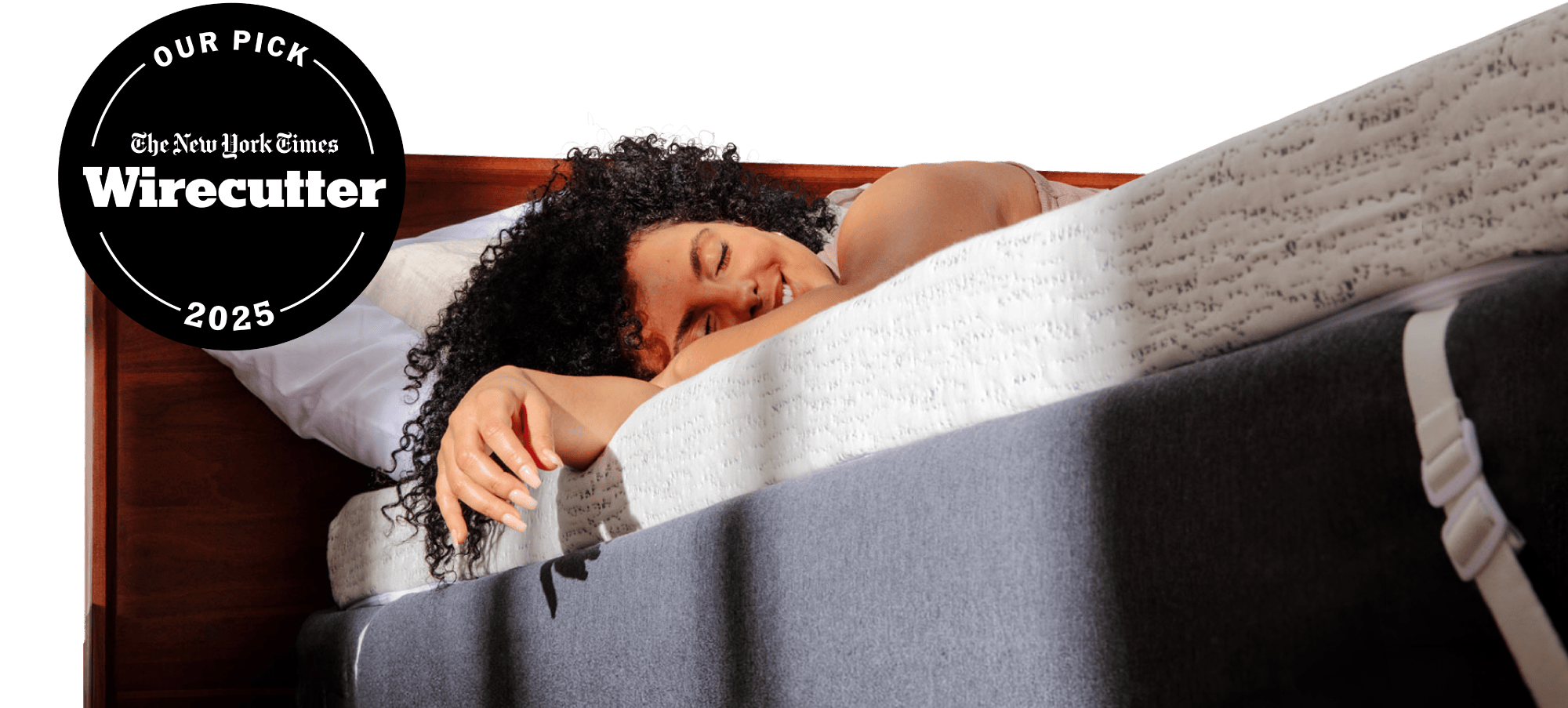 NYT Wirecutter's pick for best memory foam mattress topper; a woman relaxing on a thick white and blue mattress topper with morning light streaming on her