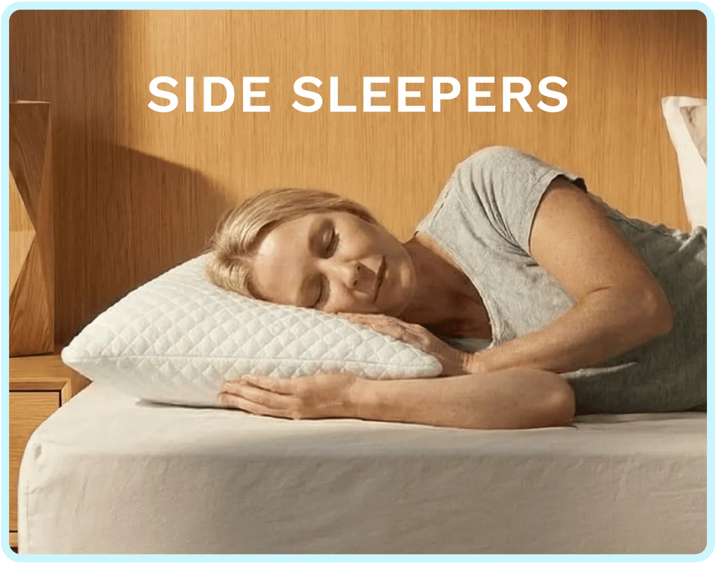 A woman sleeping on her side with a plush white pillow under her head
