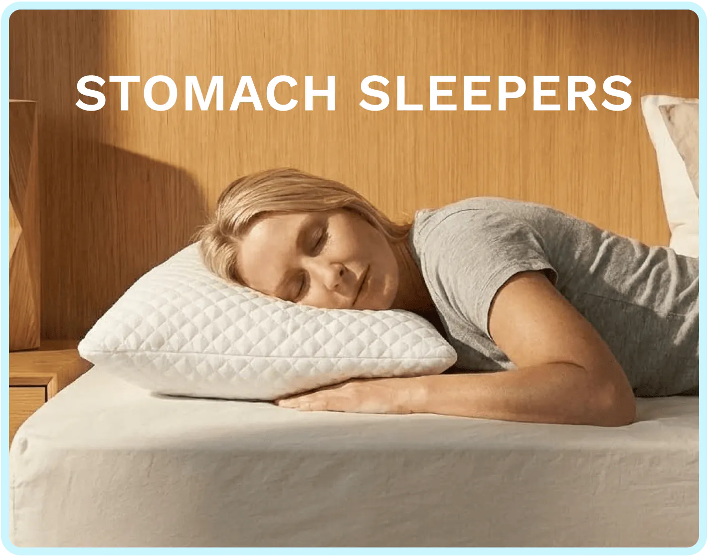 A woman sleeping on her stomach with a plush white pillow under her head