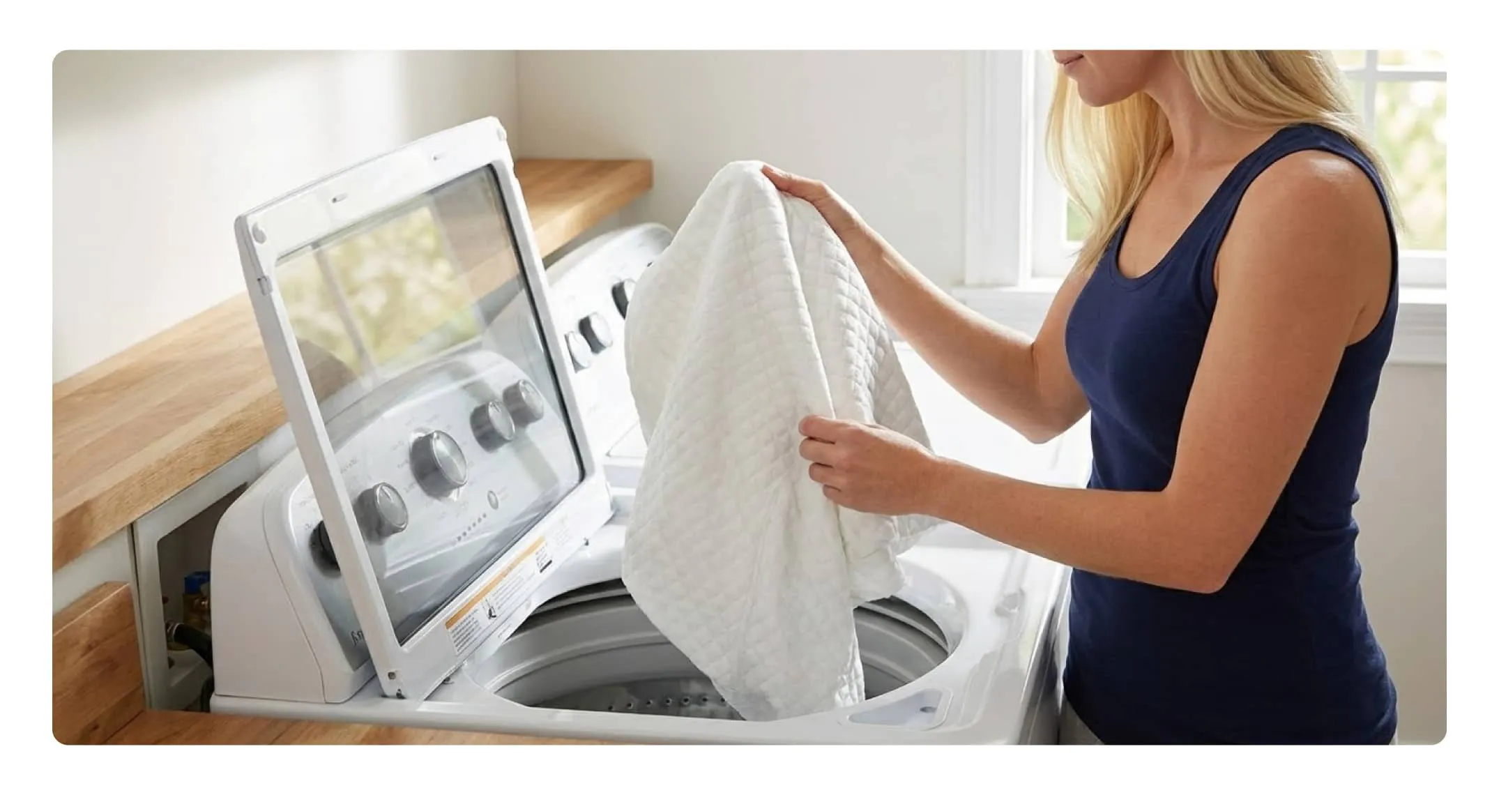A hand pressing into a pillow to show the responsive nature of the memory foam blend.