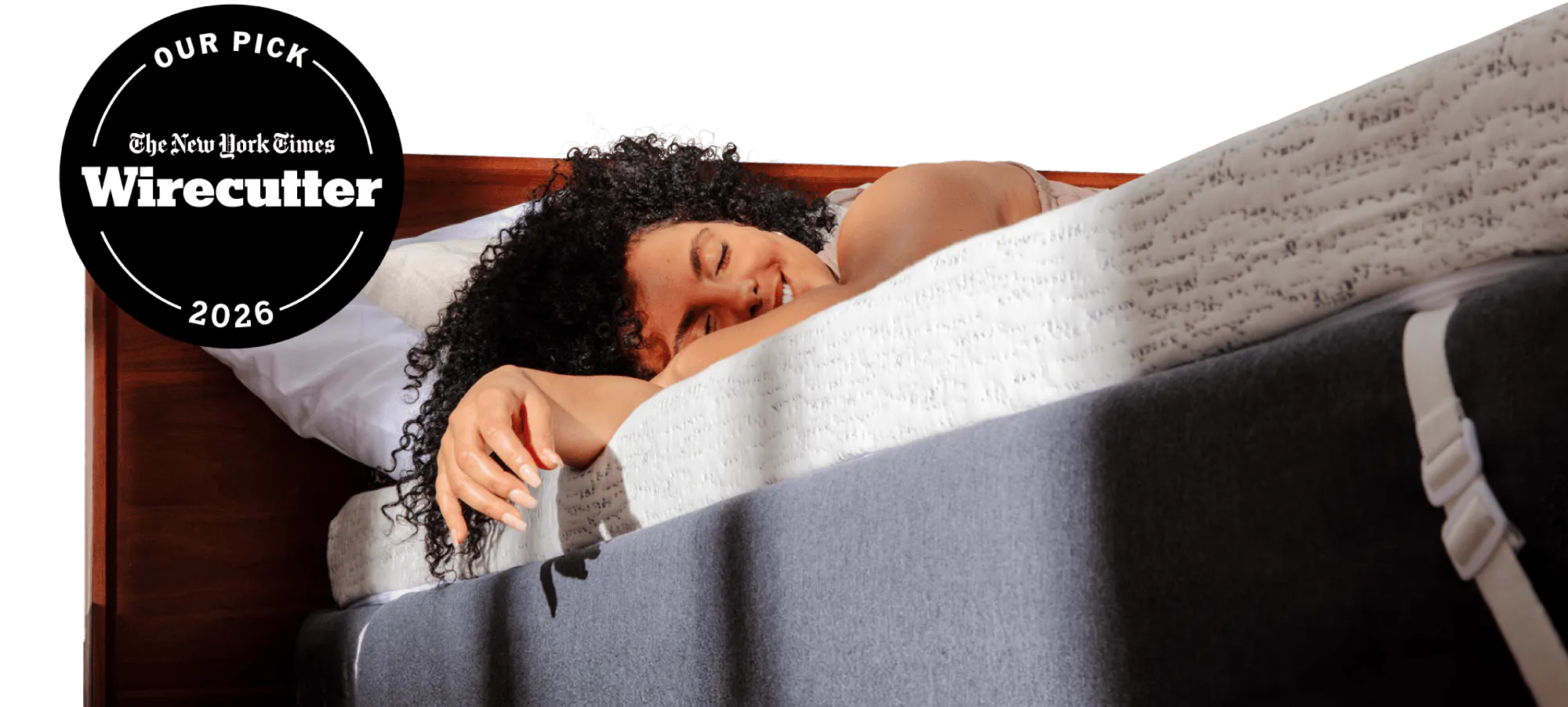 NYT Wirecutter's pick for best memory foam mattress topper; a woman relaxing on a thick white and blue mattress topper with morning light streaming on her
